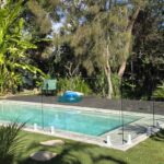 Sneaky peak into this beautiful back yard pool wrapped in our frameless glass po...