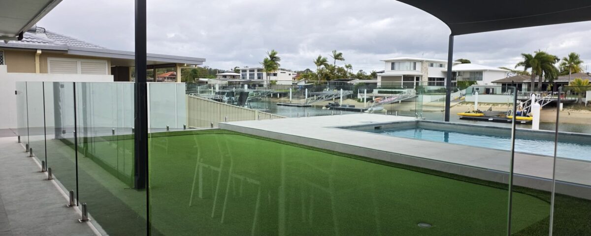 Putting green and frameless glass pool fencing, not a bad combo if you ask us!